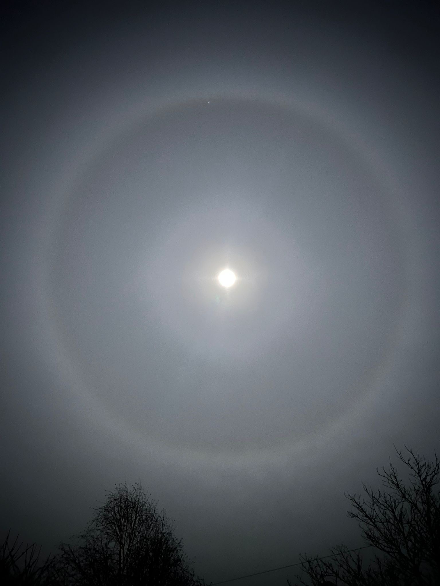 Circular halo around the moon, formed from ice crystals